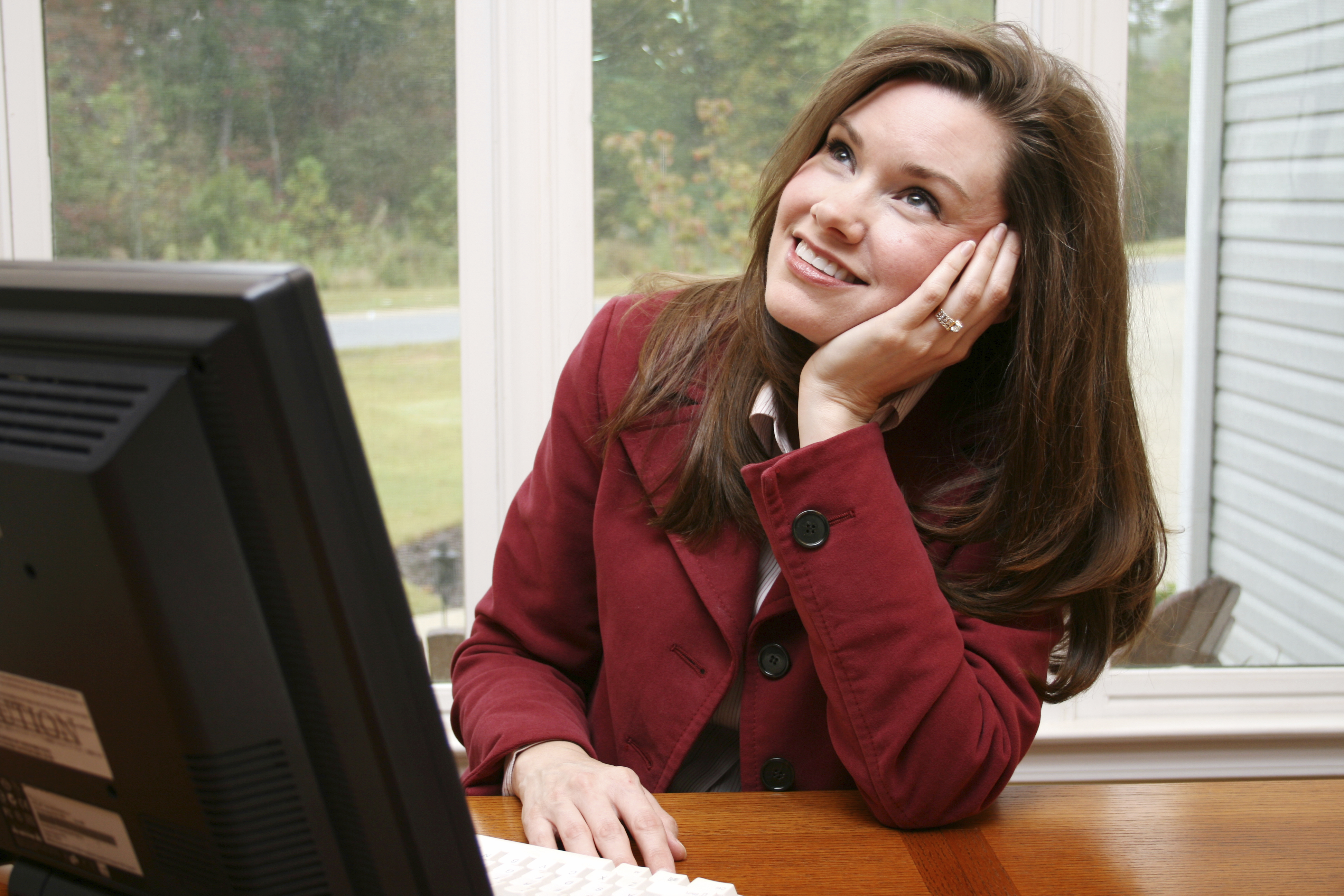 Will I ever win the lottery? woman daydreaming at work