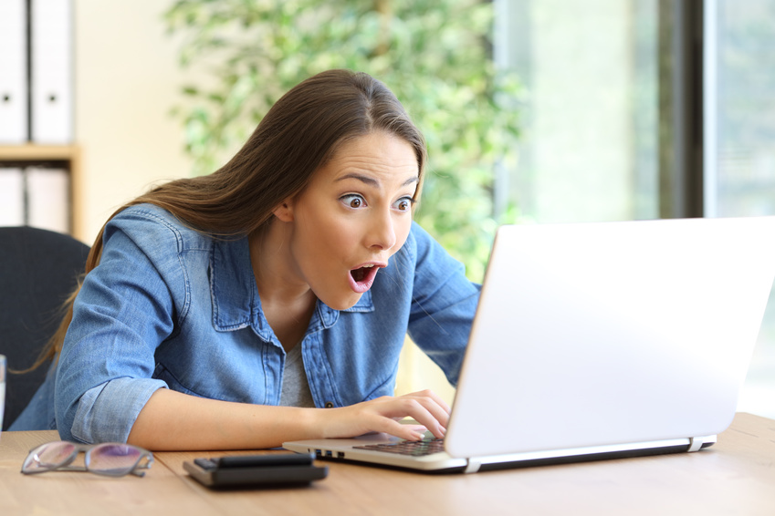 Surprised woman on laptop 