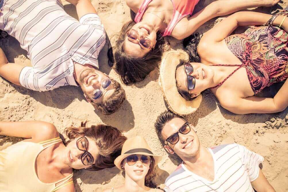 Group of friends lying on the beach