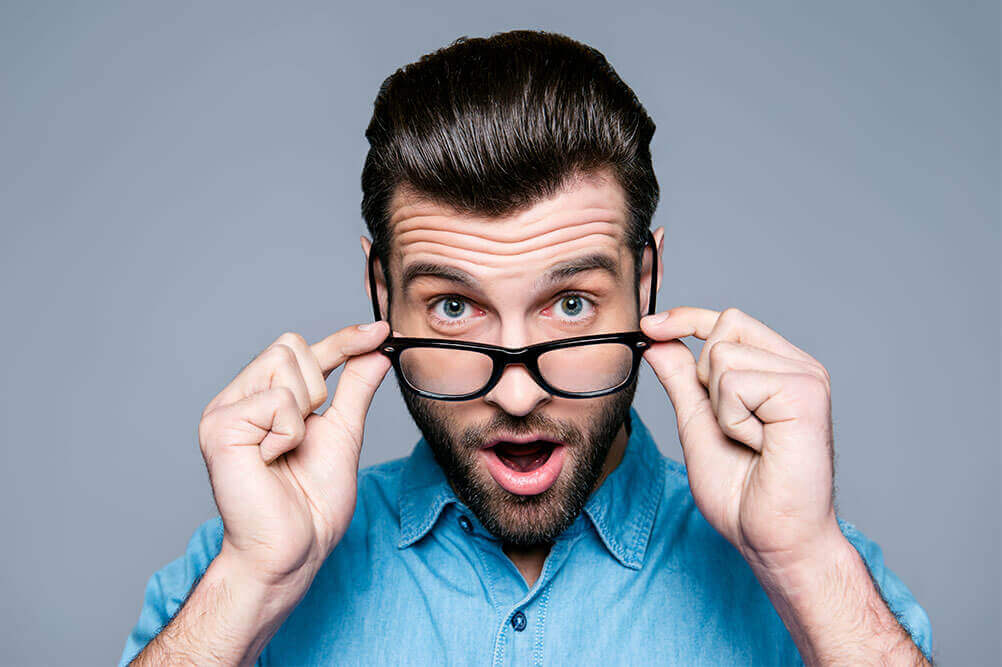 How to Choose the Best Lottery Numbers Man takes off his glasses in surprise on learning about how to choose lotto numbers.