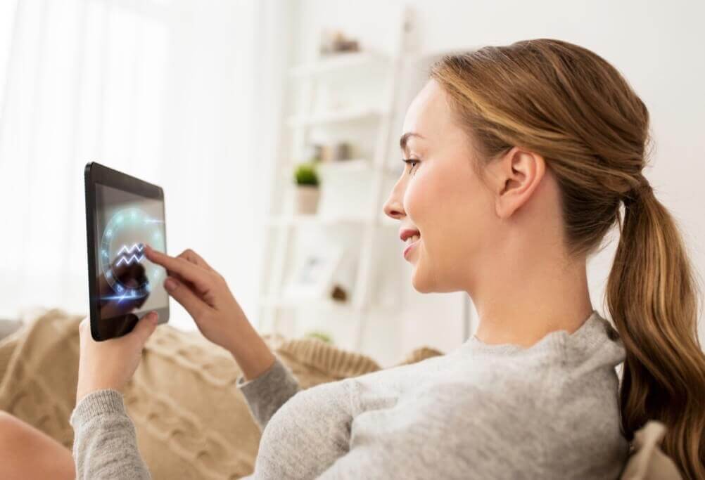 Lotto Horoscopes: Which Signs are Most Successful? Woman checking lottery results on her tablet
