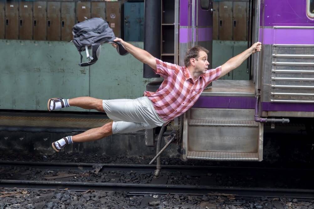 Man hangs onto a moving train