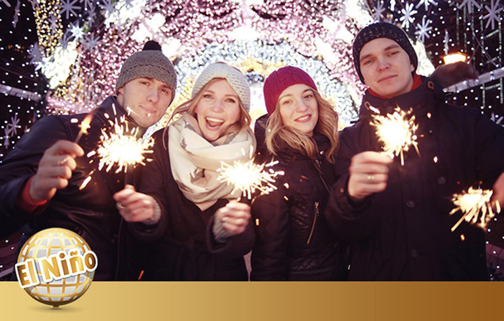 Four people hold sparklers to celebrate the El Niño Spanish lottery