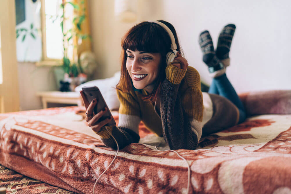 Woman  with headphones listening to music