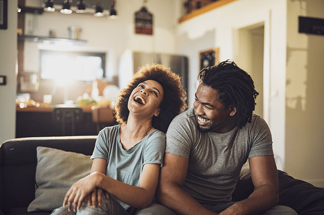 Laughing couple on a sofa