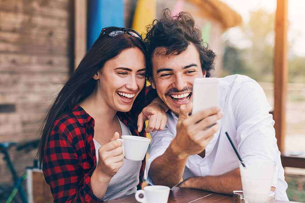 How to bet on EuroJackpot online in Ireland Laughing couple betting on EuroJackpot online with their smartphone