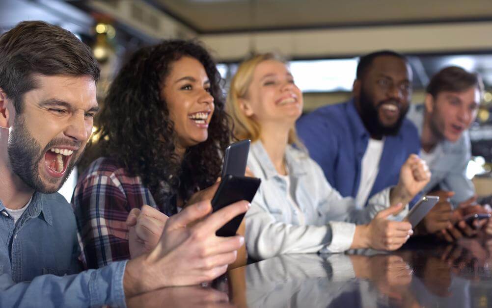 Friends Bet On Sports Friends bet on sports on their mobile phones having learned the different types of sports betting odds