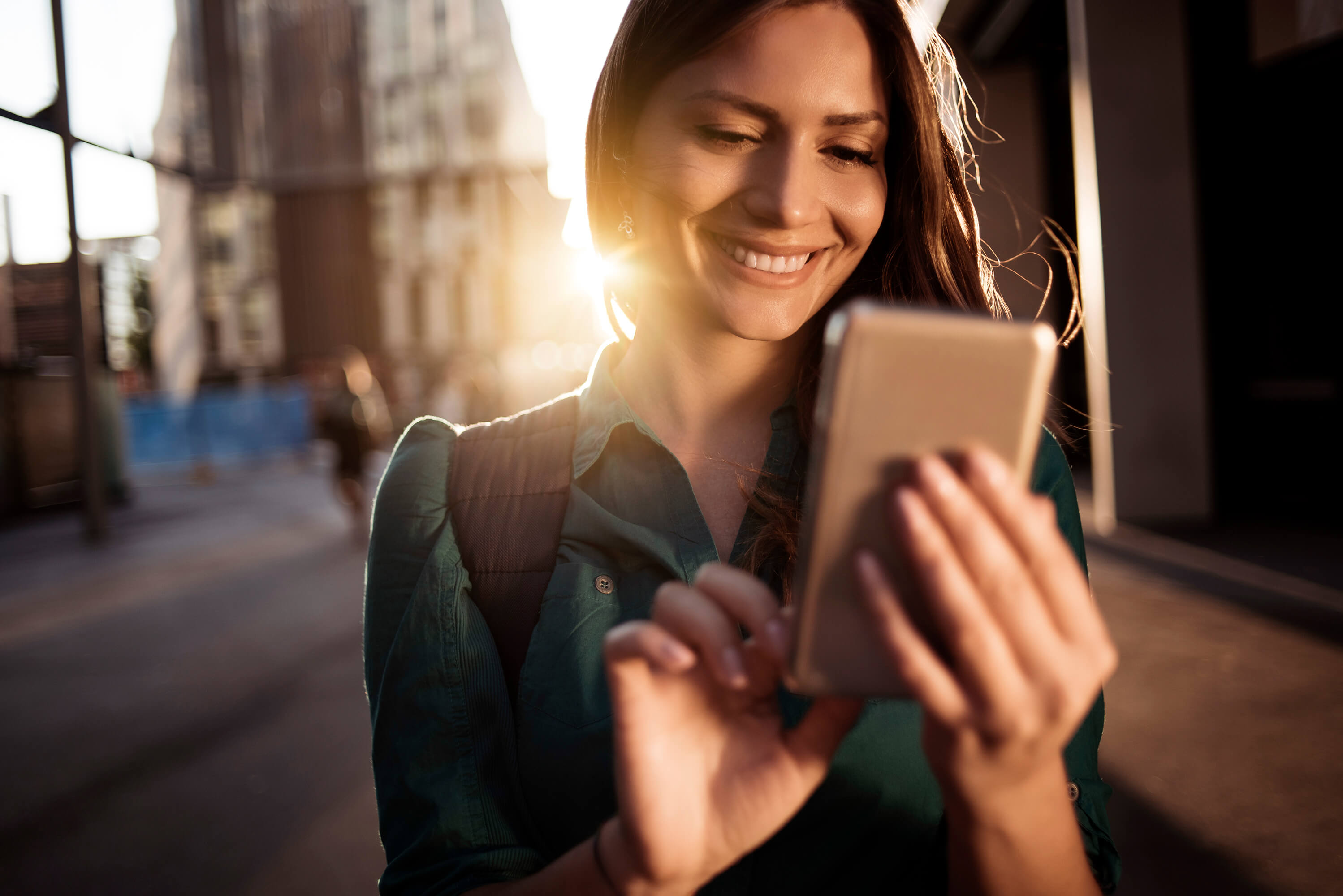 Woman betting on Eurodreams on her mobile phone on the go