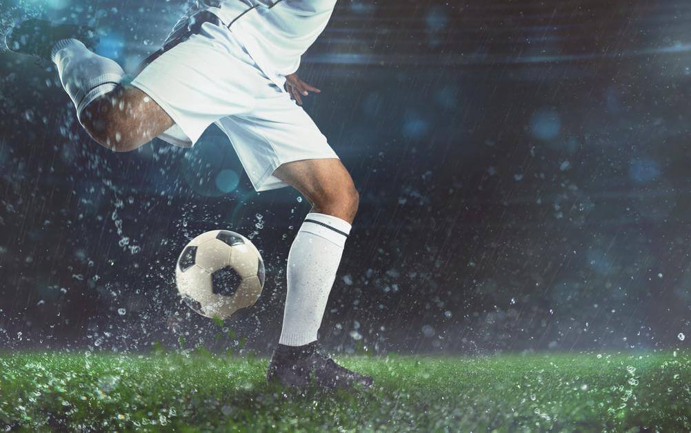 Over-Under Betting Explained A footballer, in an all-white kit about to kick a ball - will this help the over/under bet?