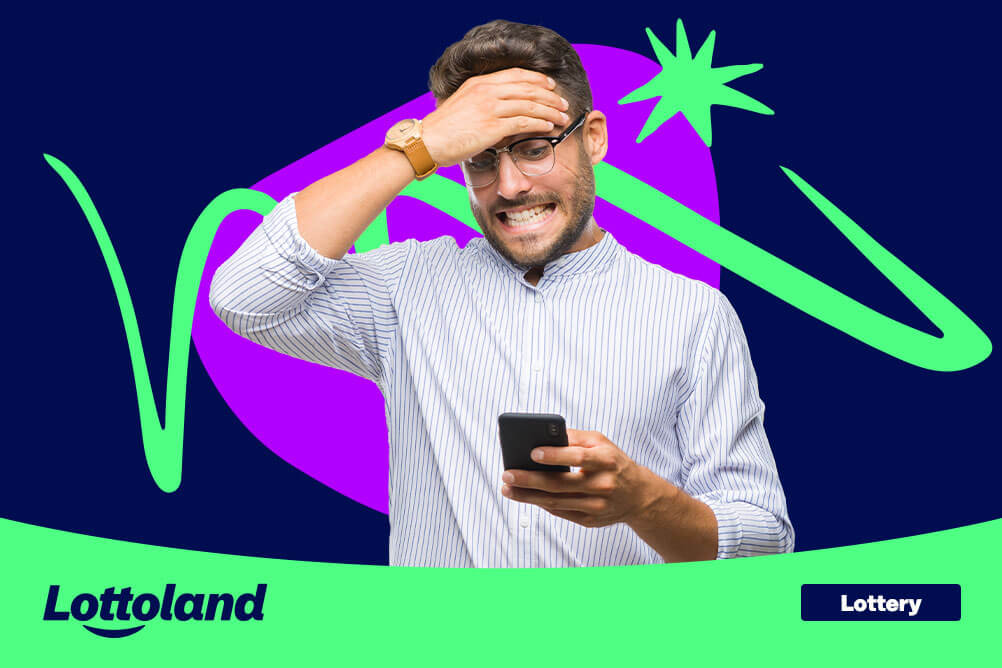 7 Lottery Mistakes That Stop You Winning Frustrated man looking at his phone in disbelief, realizing he made one of the common lottery mistakes that stop you winning.
