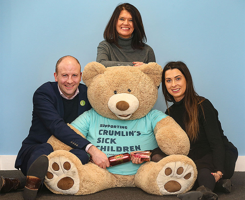 Lottoland country manager Graham Ross with representatives of Crumlin hospital next to a giant teddy bear
